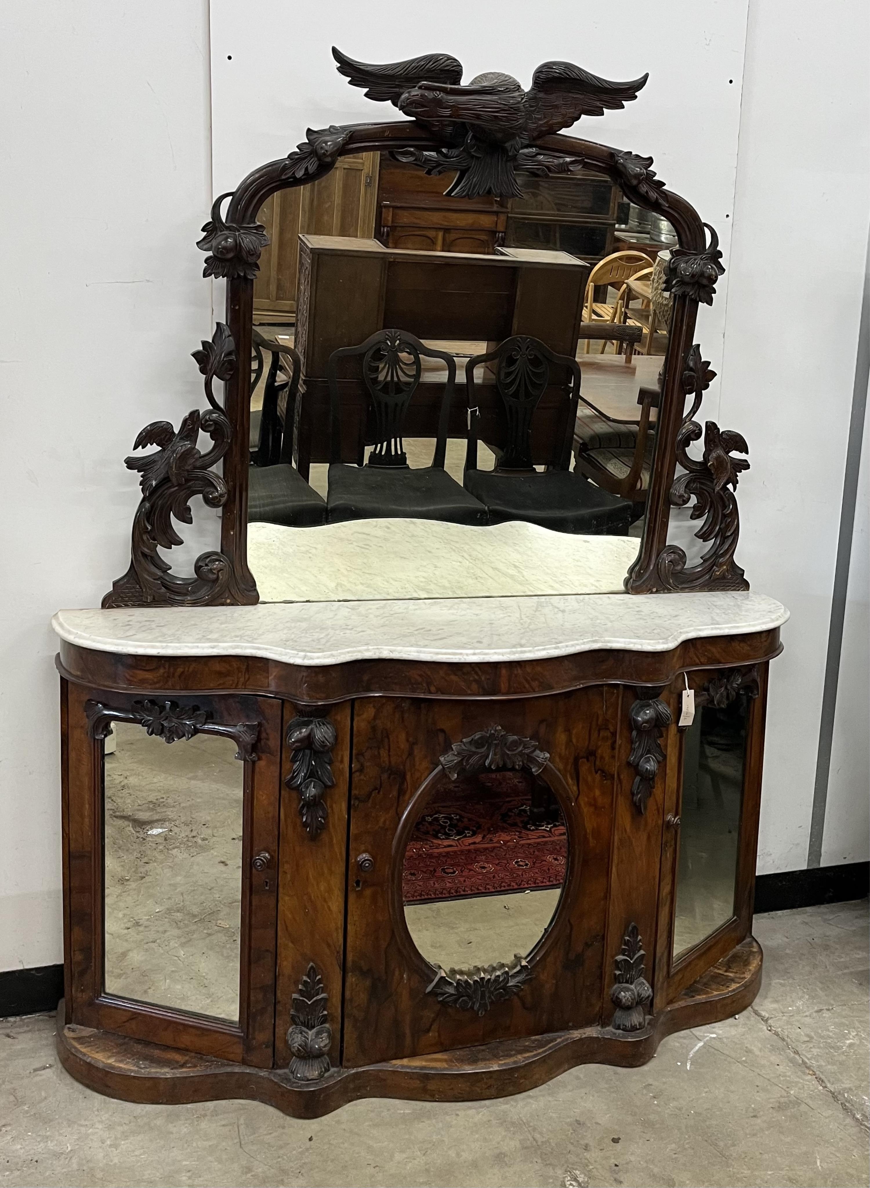 A Victorian walnut marble topped mirrored back credenza, mirror with eagle pediment, width 150cm, depth 43cm, height 125cm. Condition - poor to fair